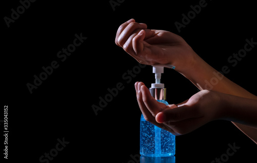 Close up. hand holding washing with alcohol 75% gel for Virus protection covid-19 or corona virus on black background.