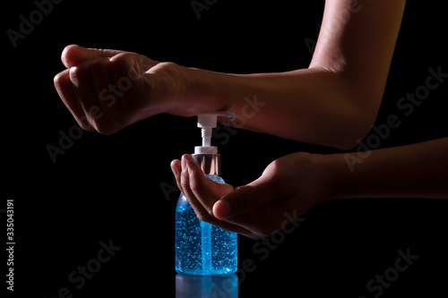 Close up. hand holding washing with alcohol 75% gel for Virus protection covid-19 or corona virus on black background.