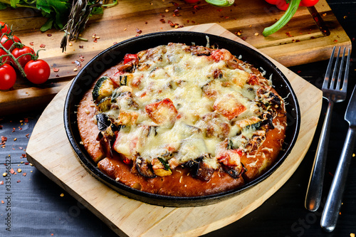 homemade pizza in a pan from the oven with vegetables