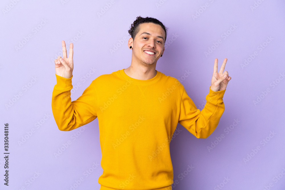 Caucasian man over isolated background showing victory sign with both hands