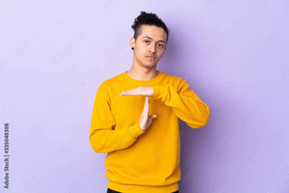 Caucasian man over isolated background making time out gesture Caucasian man over isolated background making time out gesture