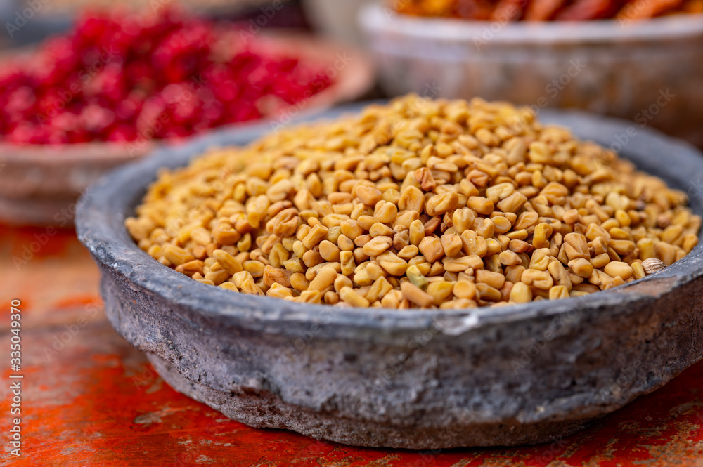 Indian spices collection, dried fenugreek seeds and another spices in clay bowls Indian spices collection, dried fenugreek seeds and another spices in clay bowls