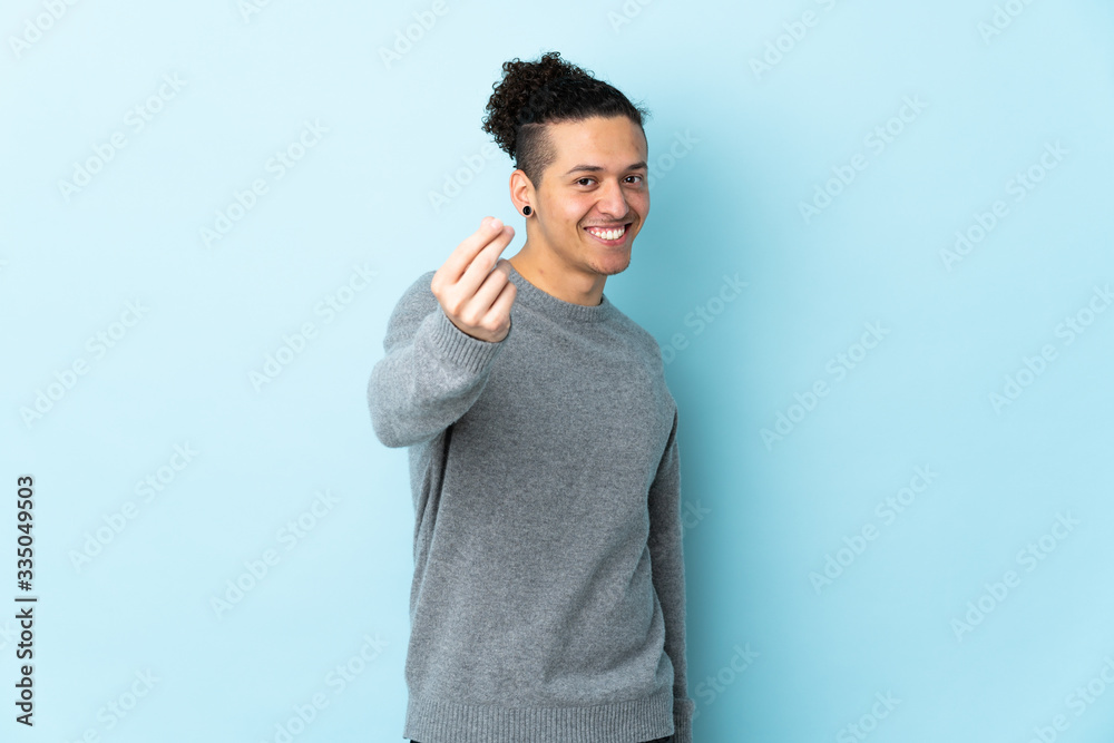 Caucasian man over isolated background making money gesture Caucasian man over isolated background making money gesture