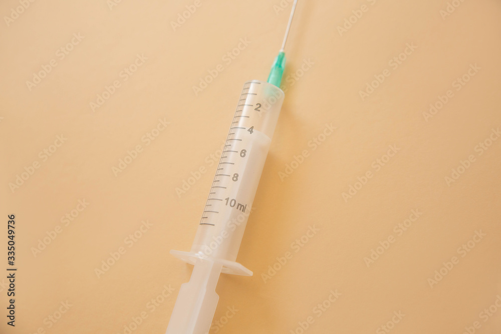 syringe with needle on beige background syringe with needle on beige background