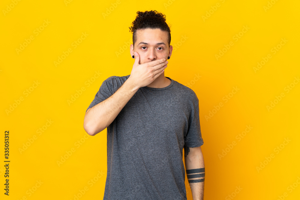 Caucasian man over isolated background covering mouth with hand Caucasian man over isolated background covering mouth with hand