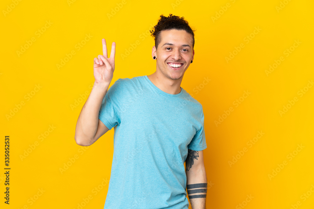 Caucasian man over isolated background smiling and showing victory sign Caucasian man over isolated background smiling and showing victory sign