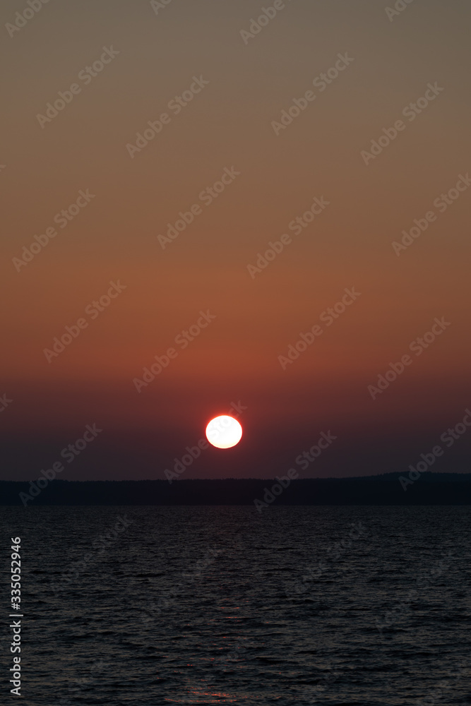 Red sunrise over lake