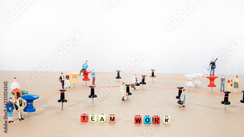 Office work abstract photo. Wired points on wooden surface with small man figures.