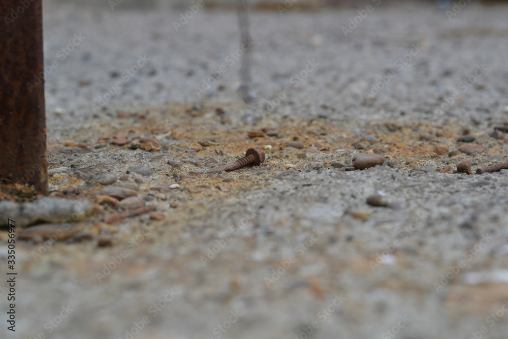 rusty screw concrete blurred background