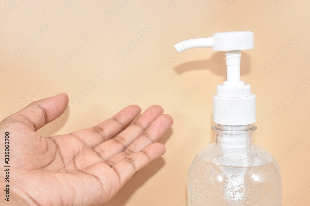 hand holding a bottle of liquid soap hand holding a bottle of liquid soap