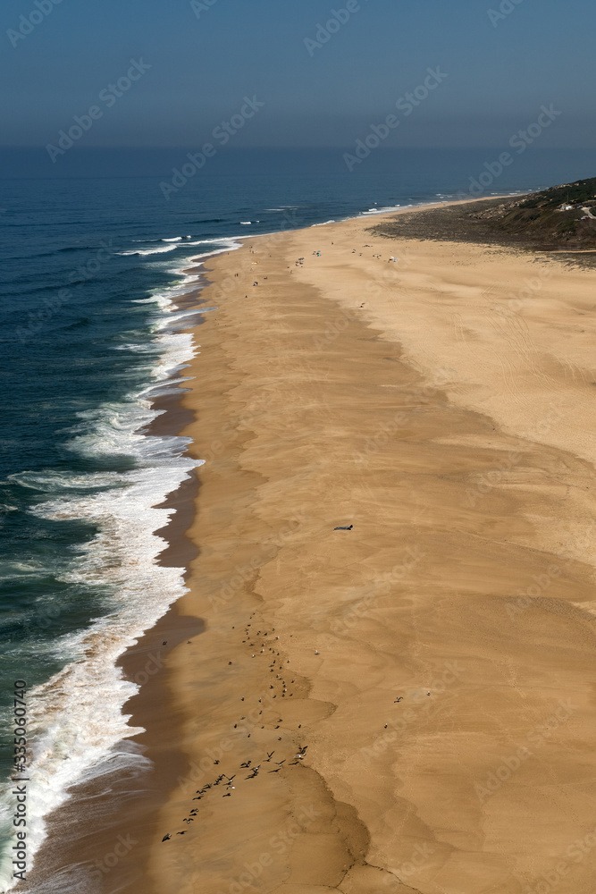 Aerial view of the Praia do Norte beach in front of the Atlantic Ocean since viewpoint. Nazare, Portugal