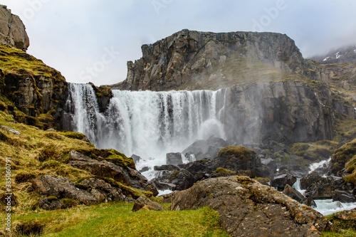 Waterfall in winter, Reyoarfjorour fjord, Iceland.