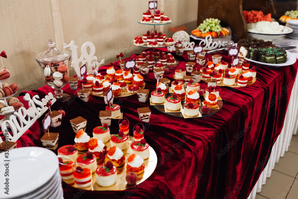 candy bar with cupcakes on a golden tray decorated with raspberr