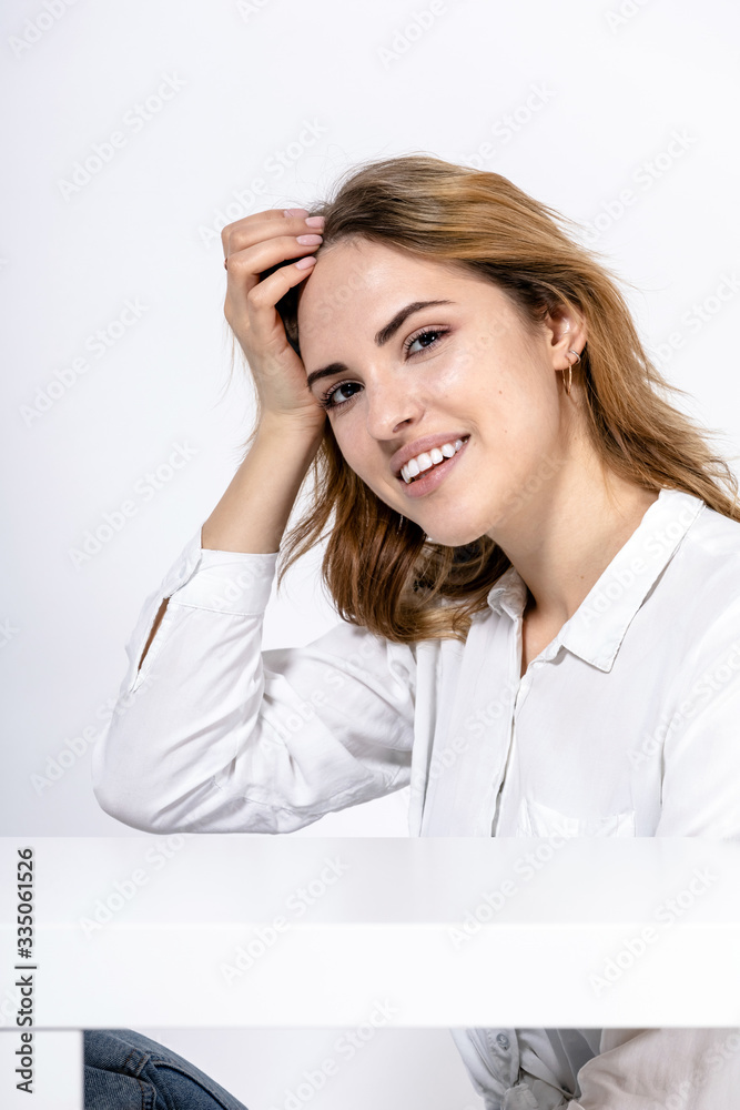 portrait of a young happy smiling girl in a white shirt on a white background portrait of a young happy smiling girl in a white shirt on a white background