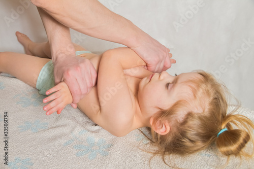 doctor has a child on the massage table on the procedure