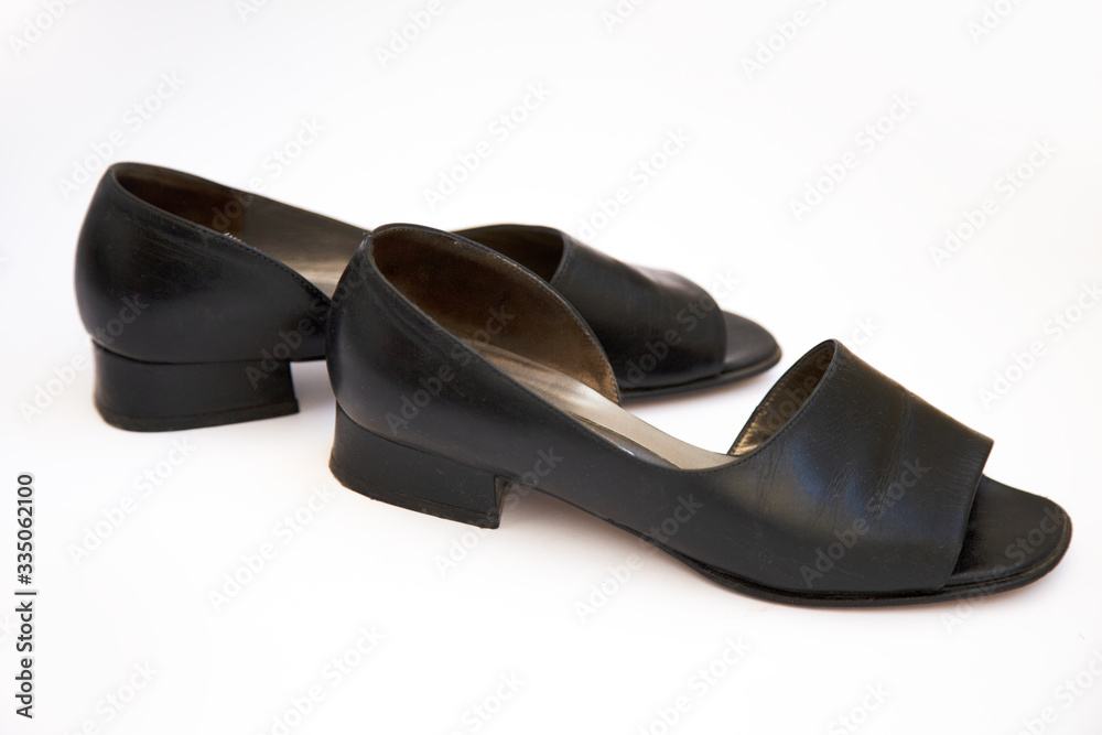 black female shoes on a white background. Flat lay, top view of fashionable beauty female background. black female shoes on a white background. Flat lay, top view of fashionable beauty female background.