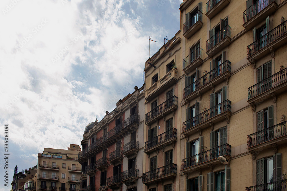 View of historical, traditional, typical buildings showing Spanish / Catalan architectural style in Barcelona. It is a summer day.