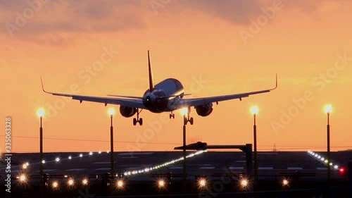 Passenger plane landing in the evening light Manchester airport UK 4K