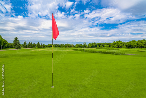 Red flag at beautiful golf course in green park at Mezhgorye residence, Ukraine
