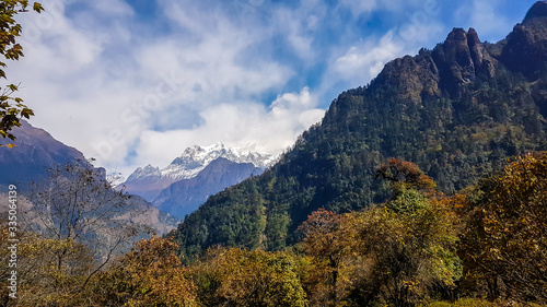 Manaslu  the eighth highest mountain in the world at 8 163 m  Annapurna Circuit Trek  Nepal. Seen from a far in Chame. Another mountain covers the straight view on Manaslu. Light clouds over the peak.