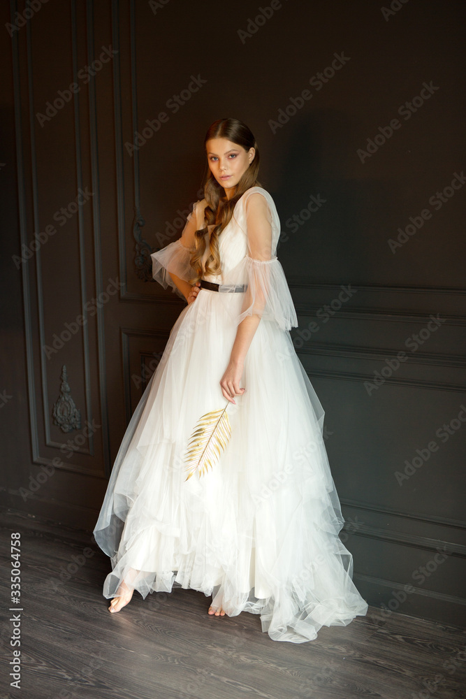 portrait of a beautiful young woman with makeup in a wedding dress