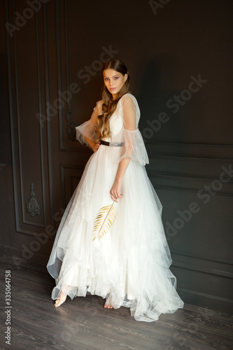 portrait of a beautiful young woman with makeup in a wedding dress