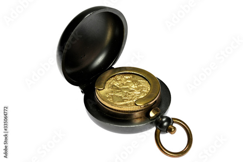British full Sovereign gold coin in gunmetal case isolated on white background