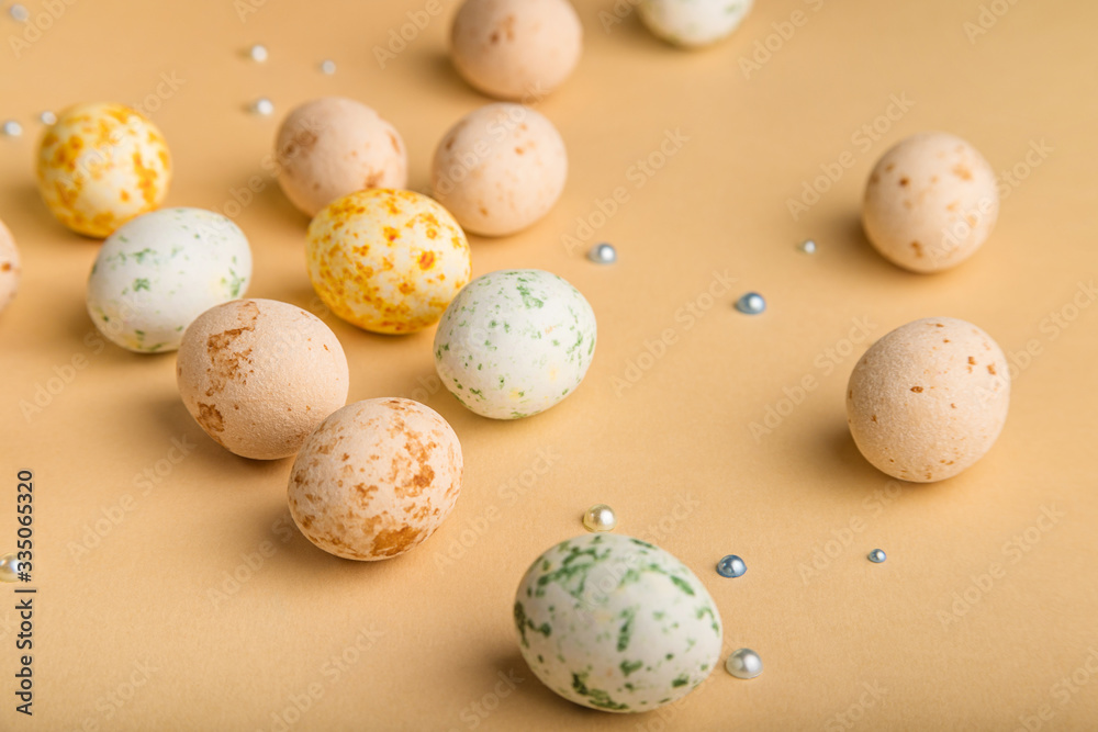 Easter background with beige marzipan eggs on beige background