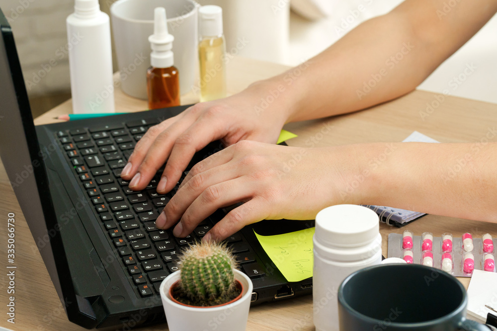 Hands typing on laptop keyboard in an office close up Hands typing on laptop keyboard in an office close up