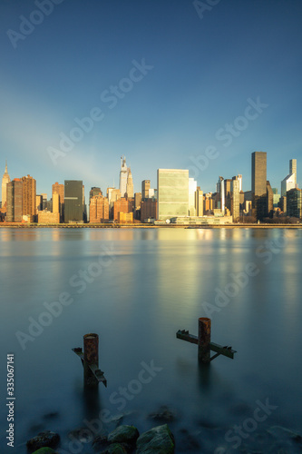 Midtown Manhattan during the golden hour from the east river with long exposure