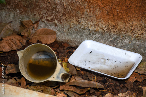 plastic bowl abandoned in a vase with stagnant water inside. close up view. mosquitoes in potential breeding ground.proliferation of aedes aegypti mosquitoes, dengue, chikungunya, zika virus photo