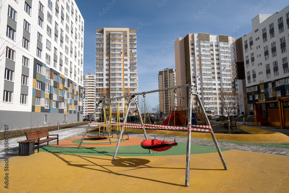 cordoned off swings on a playground in time of coronavirus quarantine - Tyumen, Russia, March 31, 2020 cordoned off swings on a playground in time of coronavirus quarantine - Tyumen, Russia, March 31, 2020