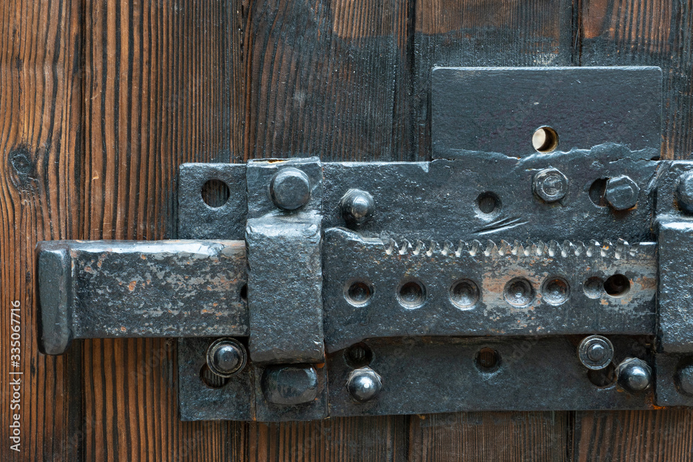 Old wooden doors. A big old iron lock. An ancient mechanism for locking doors.