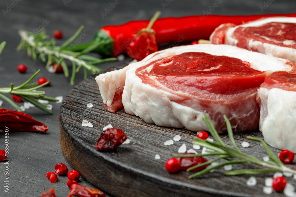 fresh meat with ingredients for cooking on dark background, close up fresh meat with ingredients for cooking on dark background, close up