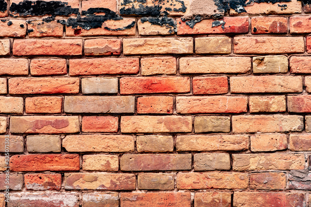 Texture of a brick wall with cracks and scratches which can be used as a background
