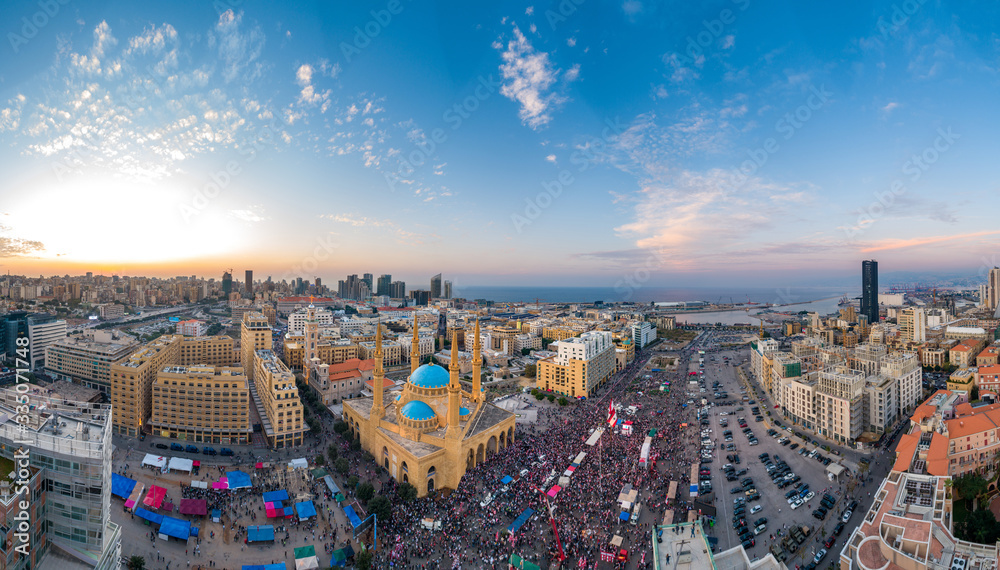 Fototapeta premium Beirut, Lebanon, 22 November 2019 : sunset drone panorama shot in Martyr square, on Lebanon independence day, during the Lebanese revolution, with thousands of people revolting against government