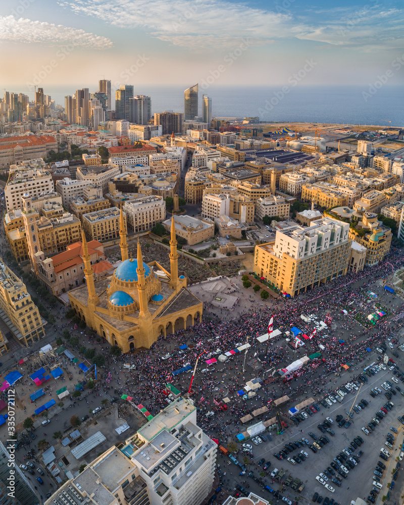 Fototapeta premium Beirut, Lebanon, 22 November 2019 : sunset drone shot in Martyr square, on Lebanon independence day, during the Lebanese revolution, with thousands of protesters revolting against government failure