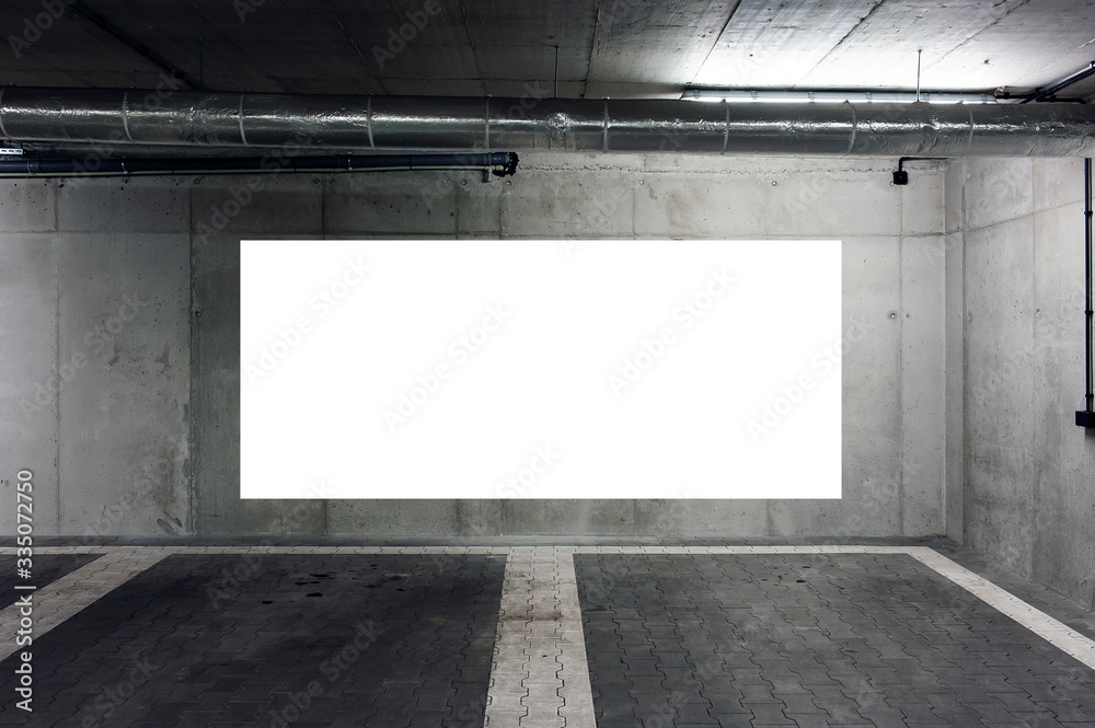 Blank white banner for advertisement on the wall of underground car park