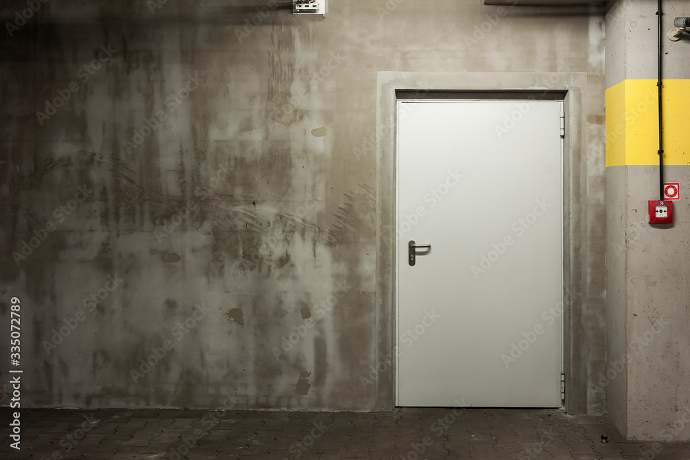 Steel door in the underground car park Steel door in the underground car park