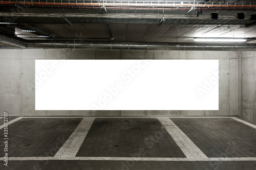Blank white banner for advertisement on the wall of underground car park