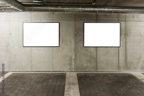 Blank white banners for advertisement on the wall of underground car park