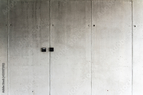 Black electric sockets on the concrete wall