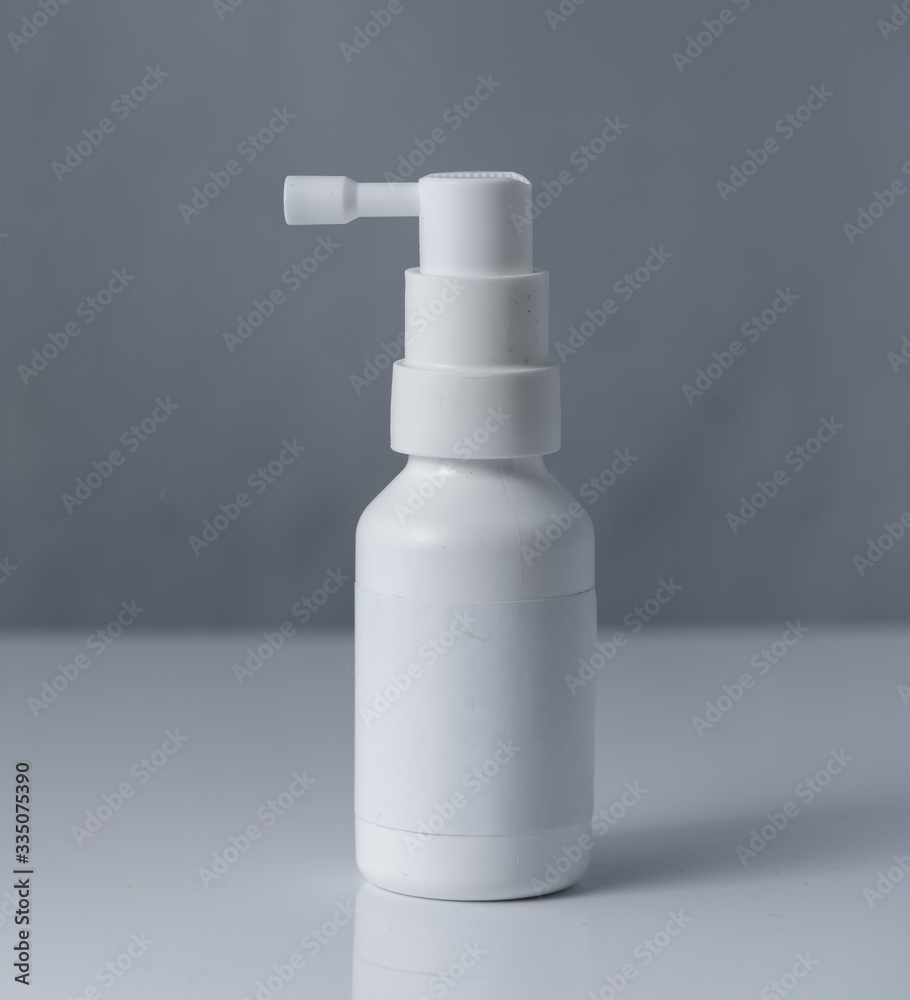 Pharmacy. Throat spray medication in white bottle isolated on white background Pharmacy. Throat spray medication in white bottle isolated on white background