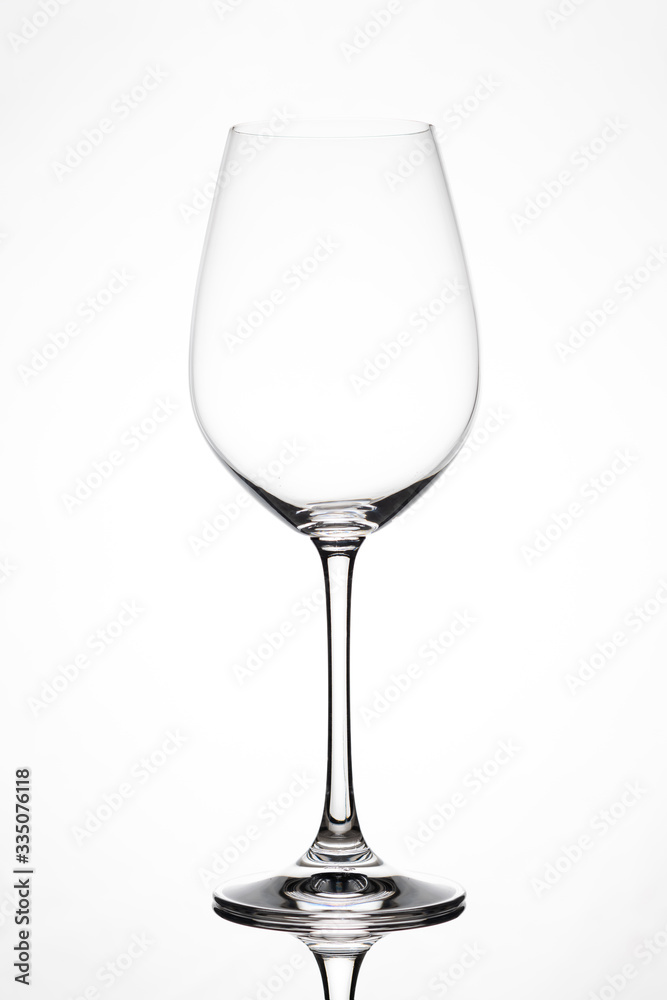 Silhouette of an empty wine glass against white background with reflection in Zurich, Europe, Switzerland. Silhouette of an empty wine glass against white background with reflection in Zurich, Europe, Switzerland.