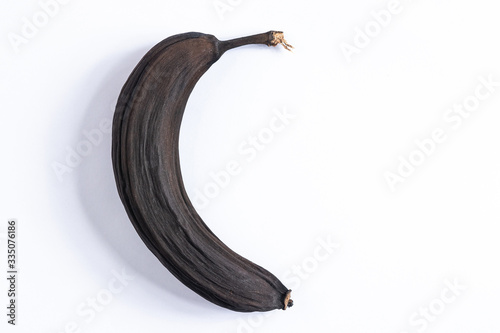 black overripe dried banana on a white background