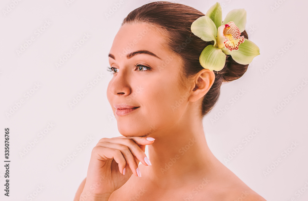 Fototapeta premium Portrait of young attractive woman beauty model with perfect face skin posing isolated on background. Beautiful girl touching smooth face and smiling. Skin treatment, beauty and wellness, peeling