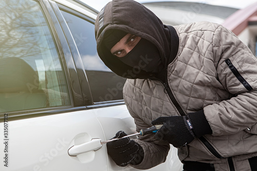 thief trying to open a car door photo