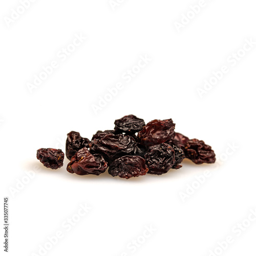 Raisins isolated on white background. Dried dark grapes. Diet healthy snack concept.