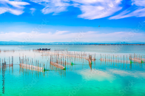 фотографія Lake landscape with turquoise waters with blue sky, white clouds and a tour boat