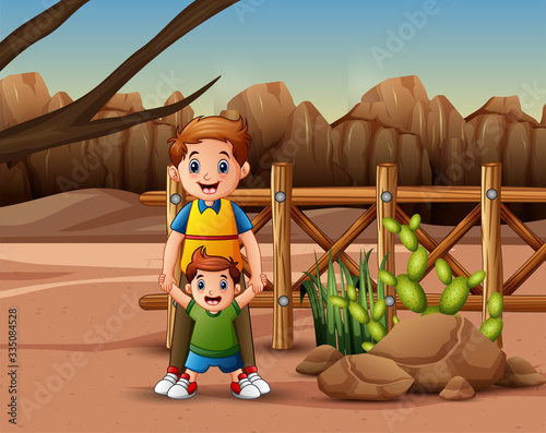 Father with his son playing on the desert